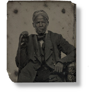 Unknown photographer Half length formal portrait of "Uncle Moreau" [Omar ibn Said]; elderly man seated wearing headwrap, suit; left elbow rests on newel, cane in right hand. Ambrotype  Randolph Linsly Simpson African-American Collection. James Weldon Johnson Memorial Collection in the Yale Collection of American Literature, Beinecke Rare Book and Manuscript Library.  https://collections.library.yale.edu/catalog/2002060